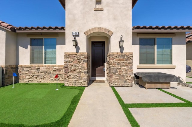 doorway to property with a patio