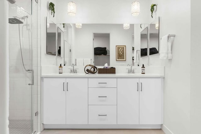 bathroom with a shower with shower door and vanity