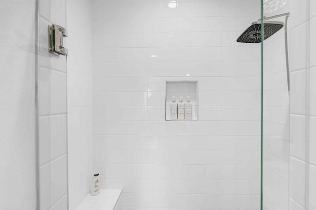 bathroom with a tile shower