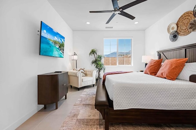 tiled bedroom featuring ceiling fan