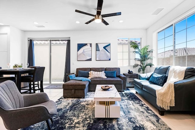 living room with ceiling fan and light tile patterned floors