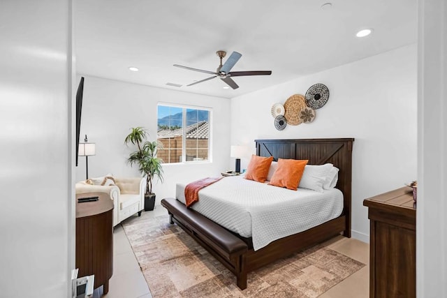 bedroom with ceiling fan and light tile patterned floors