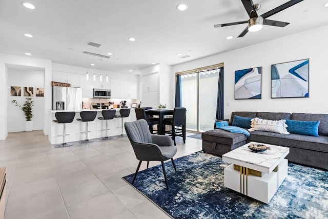 living room with ceiling fan and light tile patterned flooring