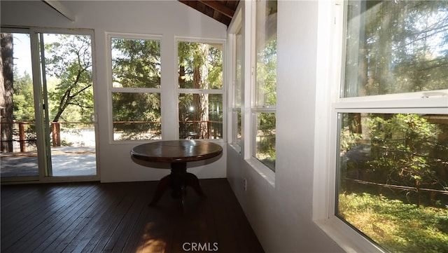 unfurnished sunroom featuring a wealth of natural light and lofted ceiling