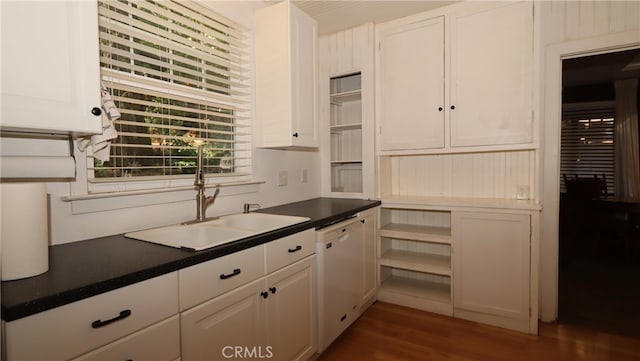 kitchen with white dishwasher, white cabinetry, dark wood-type flooring, and sink