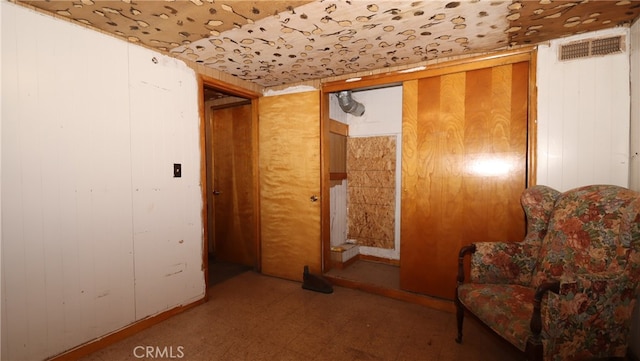 living area featuring wooden walls