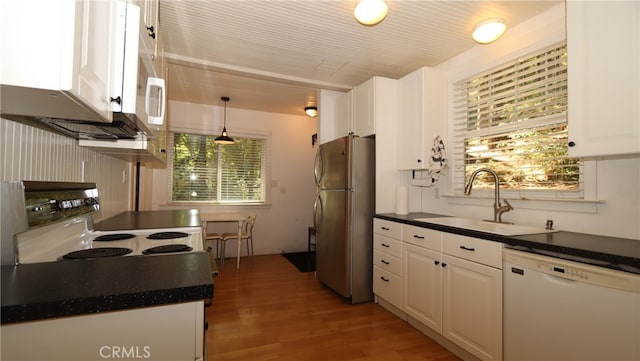 kitchen featuring sink, white appliances, decorative light fixtures, white cabinetry, and light hardwood / wood-style floors