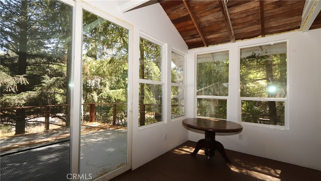 unfurnished sunroom featuring wood ceiling, vaulted ceiling with beams, and plenty of natural light