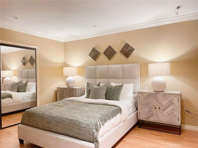 bedroom featuring wood-type flooring and ornamental molding