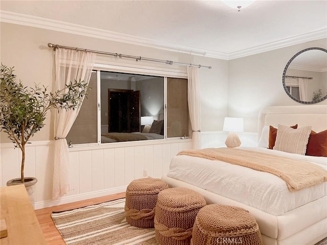 bedroom featuring wood-type flooring and crown molding