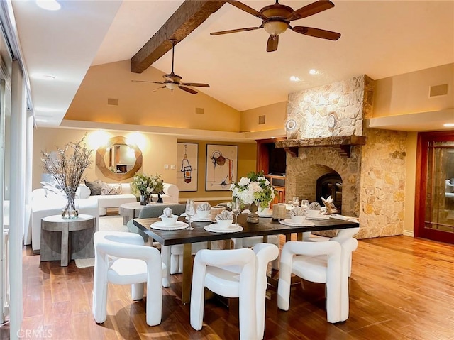 dining room with hardwood / wood-style flooring, ceiling fan, beam ceiling, and high vaulted ceiling