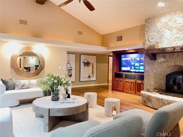 living room featuring wood-type flooring, high vaulted ceiling, and ceiling fan