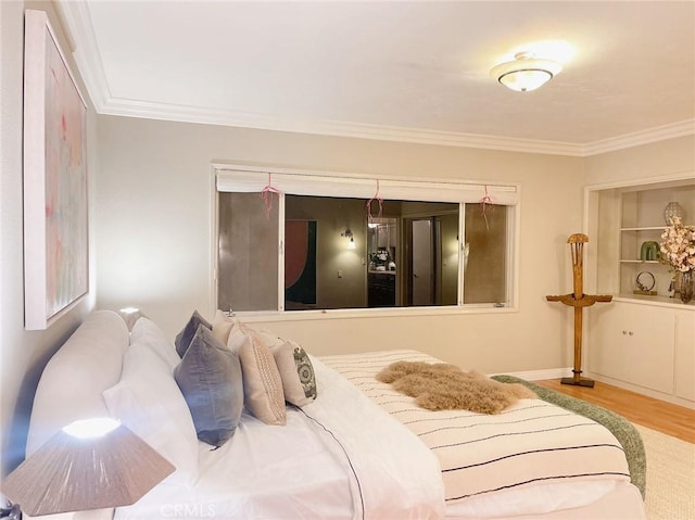 bedroom with hardwood / wood-style floors and crown molding