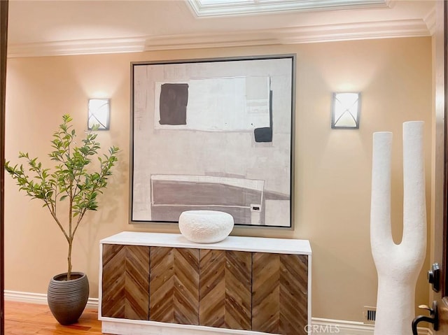 bathroom featuring hardwood / wood-style flooring and crown molding