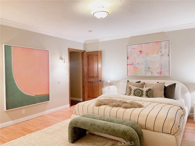 bedroom with hardwood / wood-style floors and ornamental molding