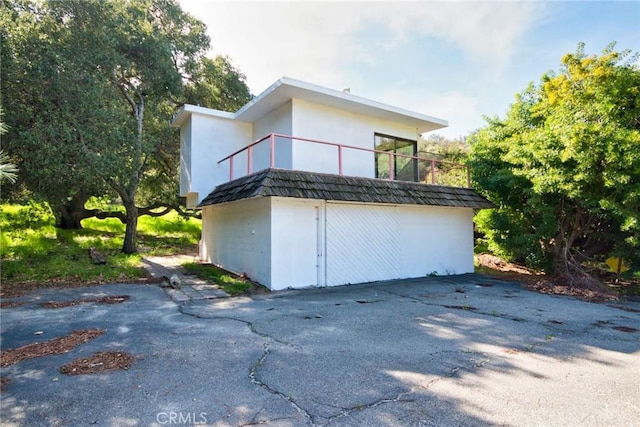 view of home's exterior with a balcony and a garage