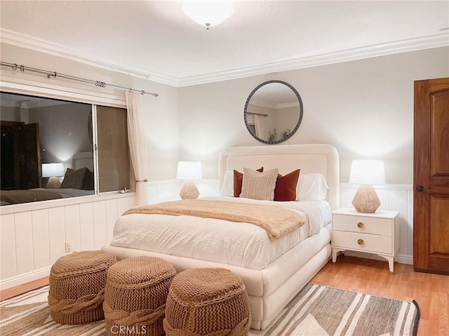 bedroom featuring light wood-type flooring and ornamental molding