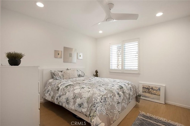 bedroom with ceiling fan and light hardwood / wood-style flooring