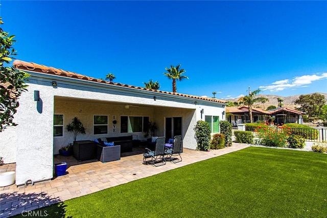 back of property featuring an outdoor living space, a yard, and a patio