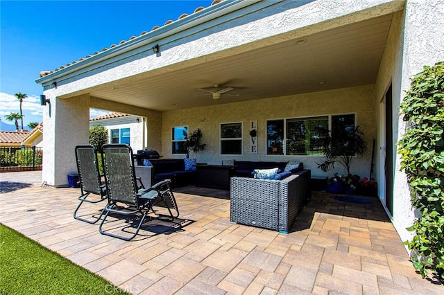 view of patio / terrace with ceiling fan and an outdoor living space