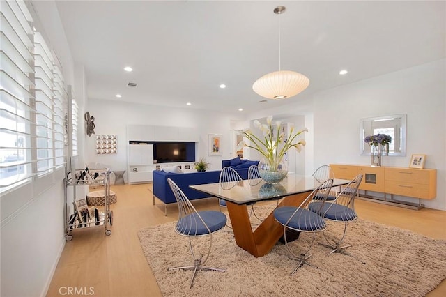 dining space with light hardwood / wood-style floors