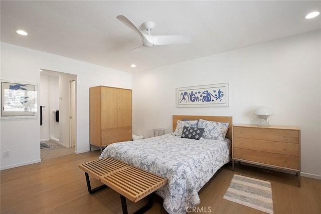 bedroom with ceiling fan and wood-type flooring