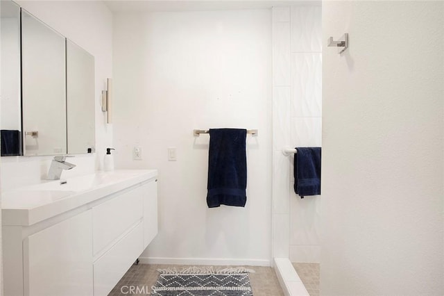 bathroom with walk in shower and vanity