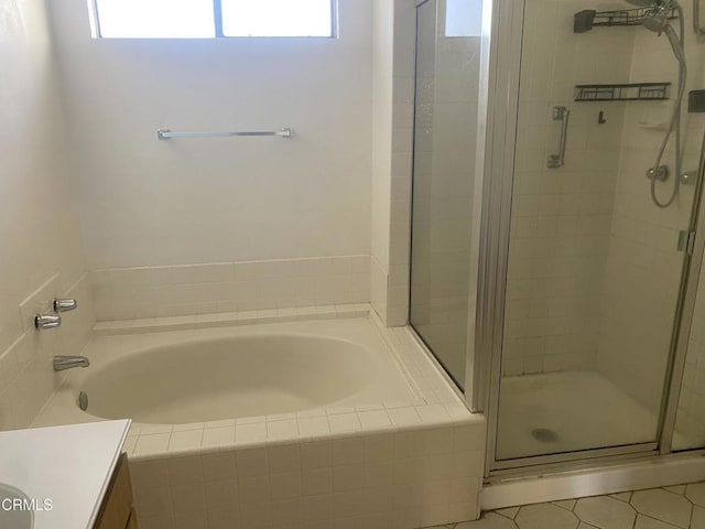 bathroom with tile patterned floors, vanity, and plus walk in shower