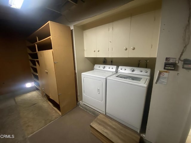 laundry room with washer and dryer and cabinets