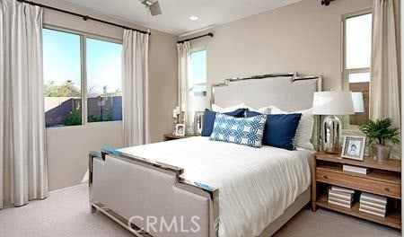 bedroom featuring ceiling fan and light colored carpet