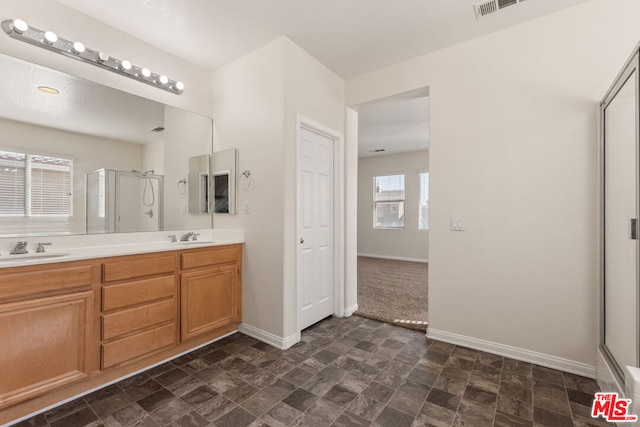 bathroom with walk in shower and vanity