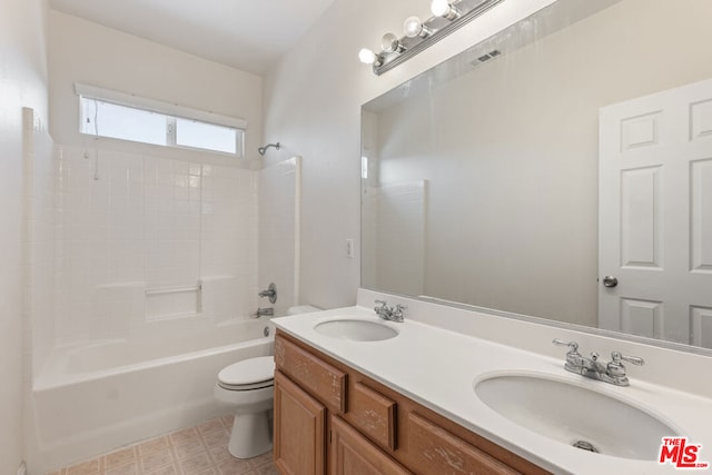 full bathroom featuring toilet, vanity, and bathing tub / shower combination