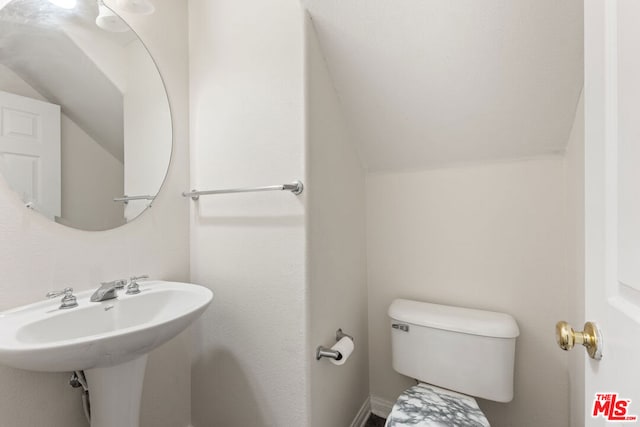 bathroom with toilet and vaulted ceiling