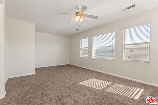 carpeted empty room with ceiling fan