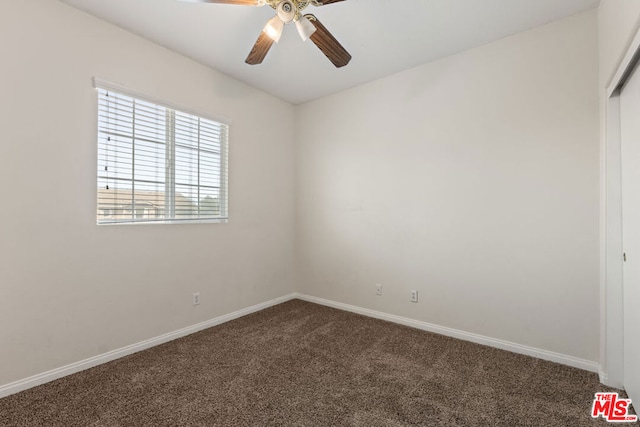 carpeted spare room with ceiling fan