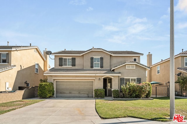 view of property with a garage and a front yard