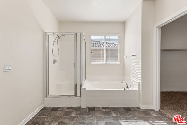 bathroom with shower with separate bathtub