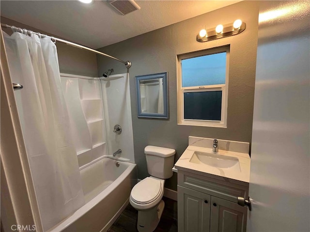 full bathroom with a textured ceiling, shower / tub combo with curtain, vanity, and toilet