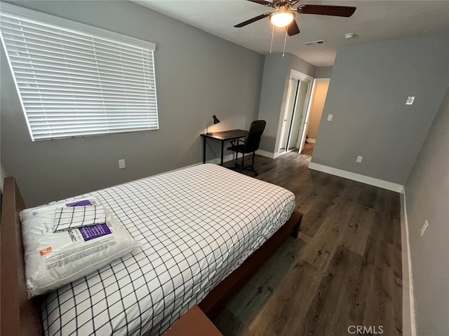 bedroom featuring dark hardwood / wood-style flooring and ceiling fan