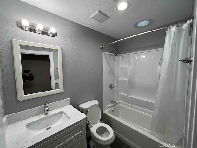 full bathroom with shower / bath combination with curtain, a textured ceiling, vanity, and toilet