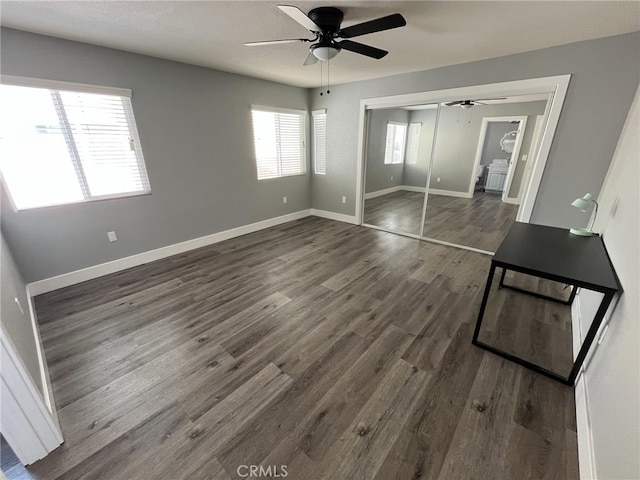 interior space featuring ceiling fan, a closet, and dark hardwood / wood-style flooring