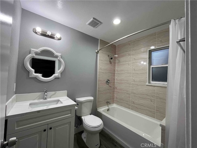 full bathroom with shower / bath combination with curtain, vanity, and toilet