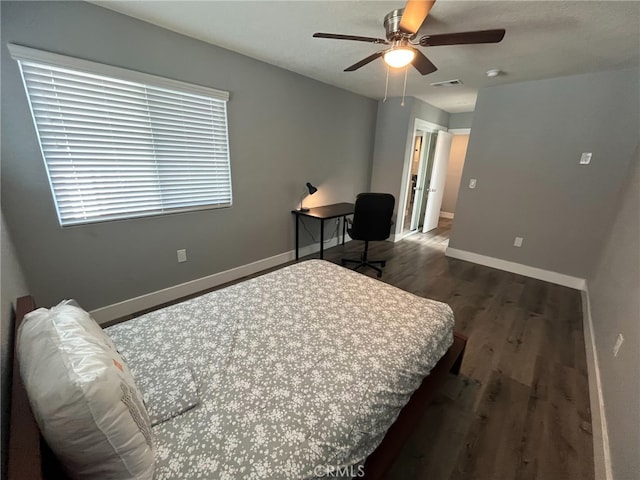 bedroom with ceiling fan and dark hardwood / wood-style flooring