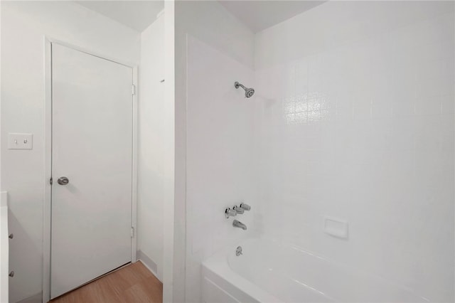 bathroom featuring tiled shower / bath combo and hardwood / wood-style floors