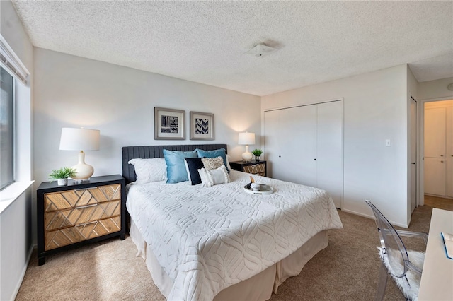 bedroom featuring a textured ceiling, carpet, and a closet