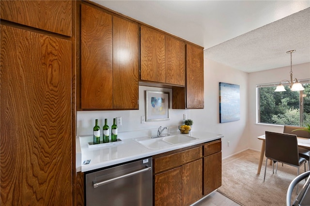 kitchen with dishwasher, a textured ceiling, decorative light fixtures, sink, and a notable chandelier