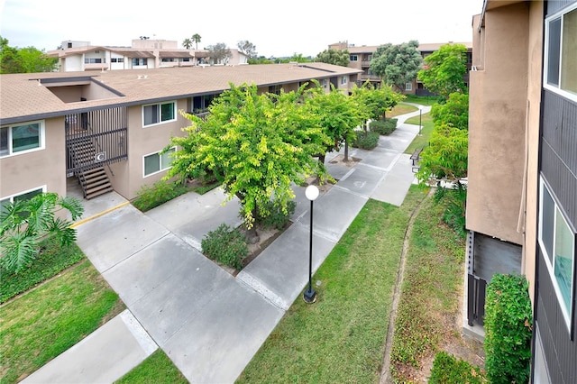 view of home's community featuring a lawn