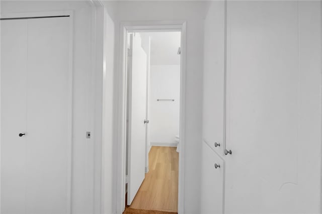 hallway with wood-type flooring