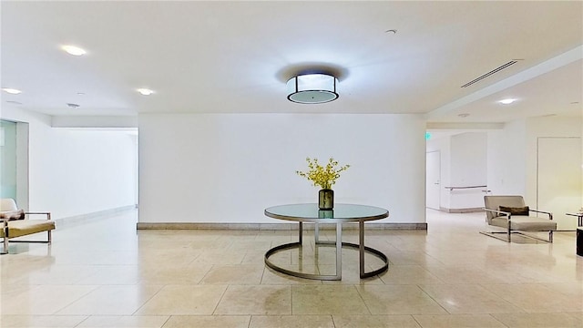 interior space with light tile patterned floors, baseboards, and visible vents