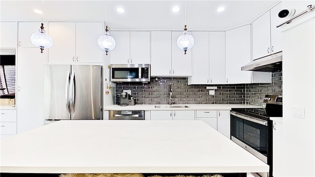 kitchen featuring white cabinetry, sink, pendant lighting, and stainless steel appliances